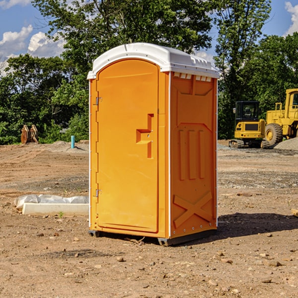 what is the cost difference between standard and deluxe portable toilet rentals in Bruno